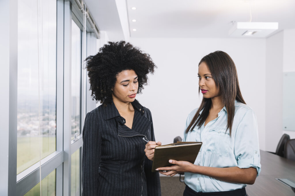 african-american-women-with-documents-near-window-office